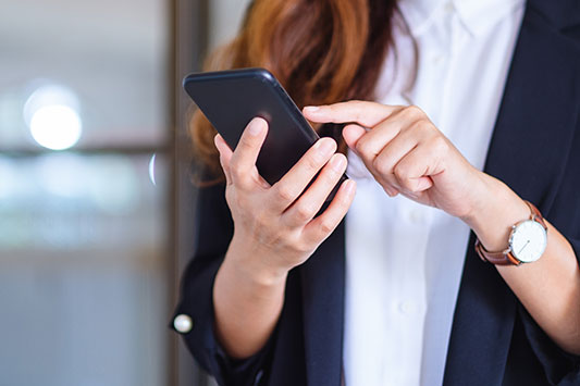 Woman with her mobile phone in hand making a call